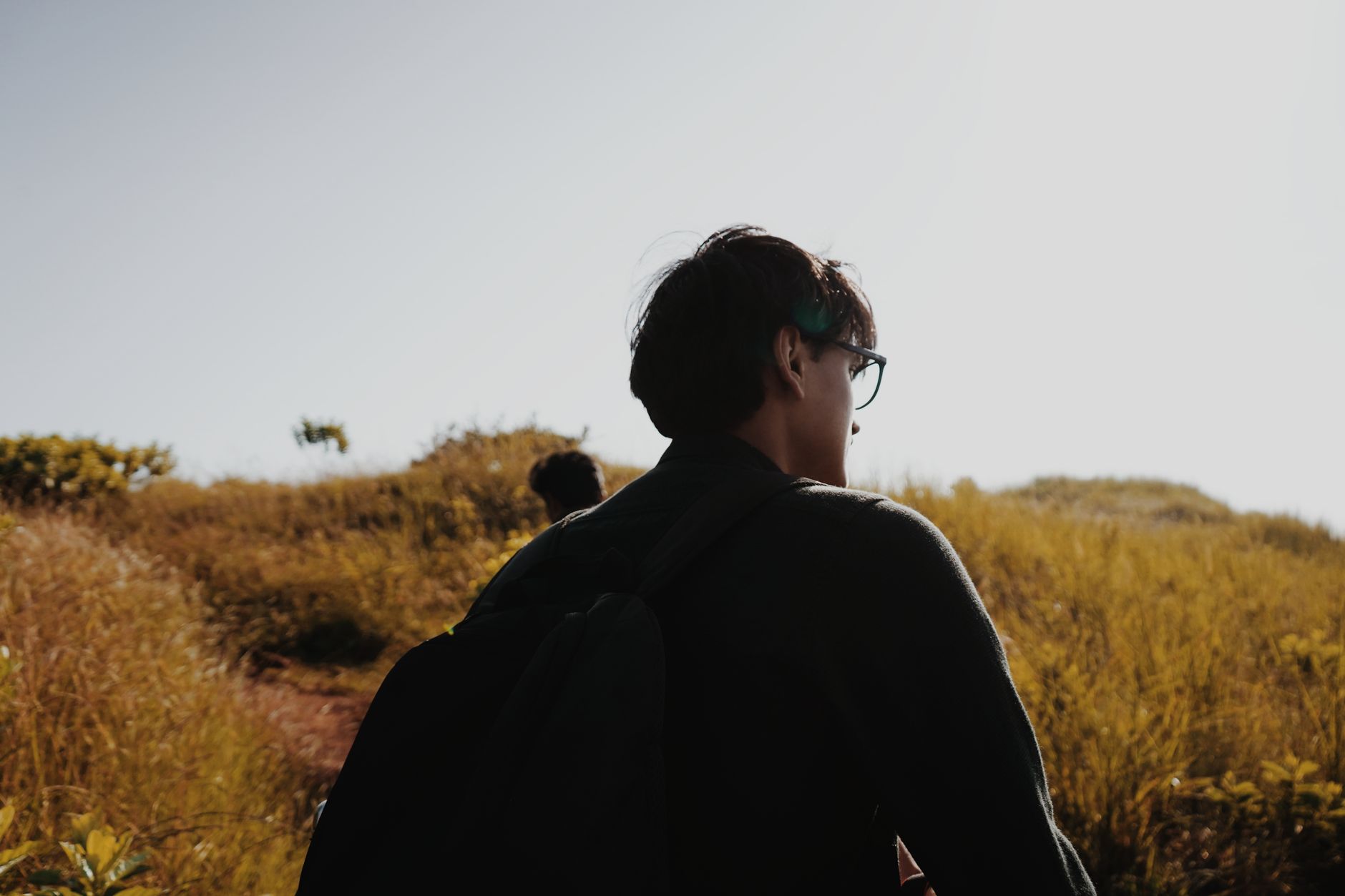 A young man out on a sunlit hill