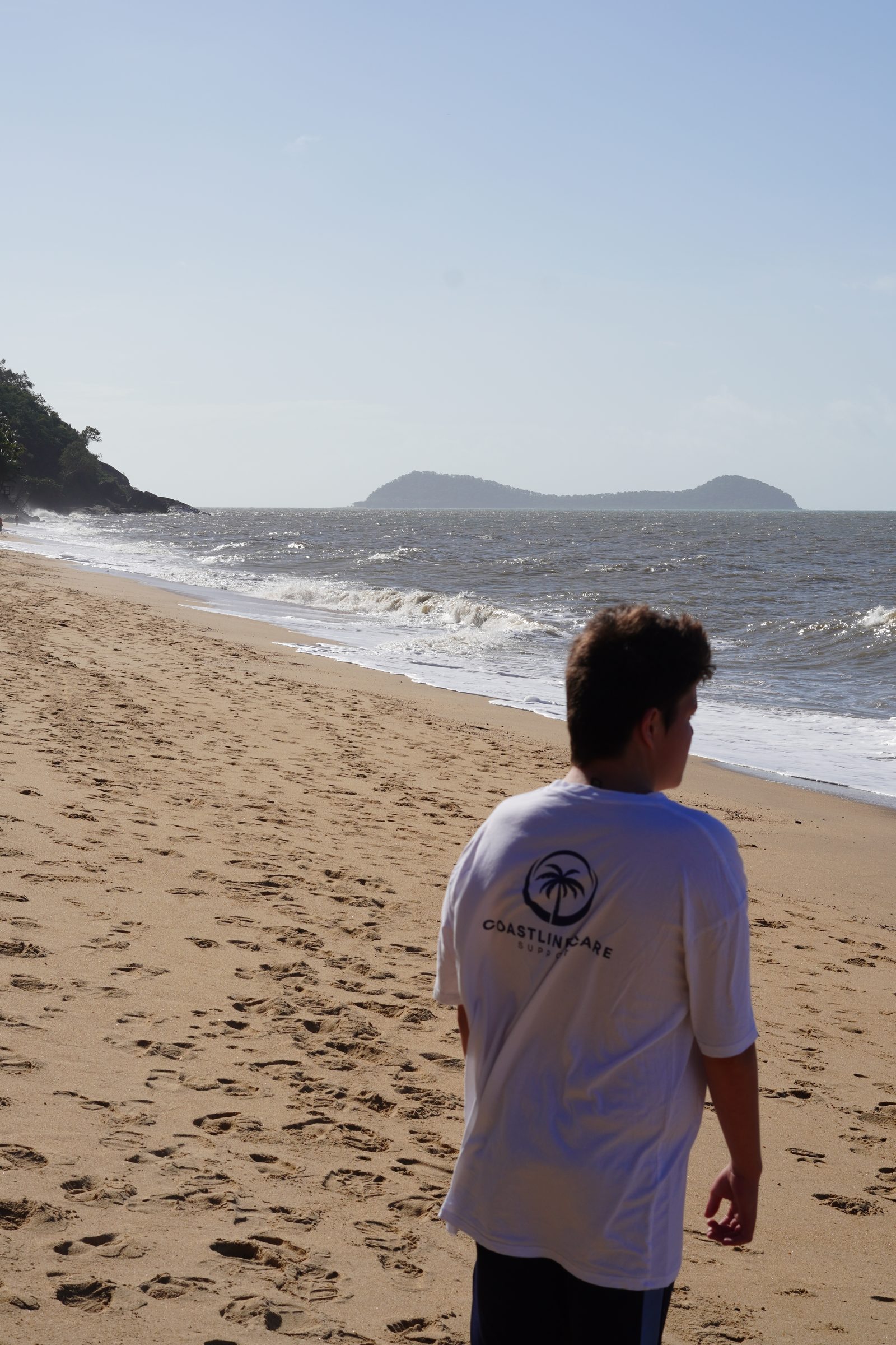 A Coastline Care support worker out on a Cairns beach